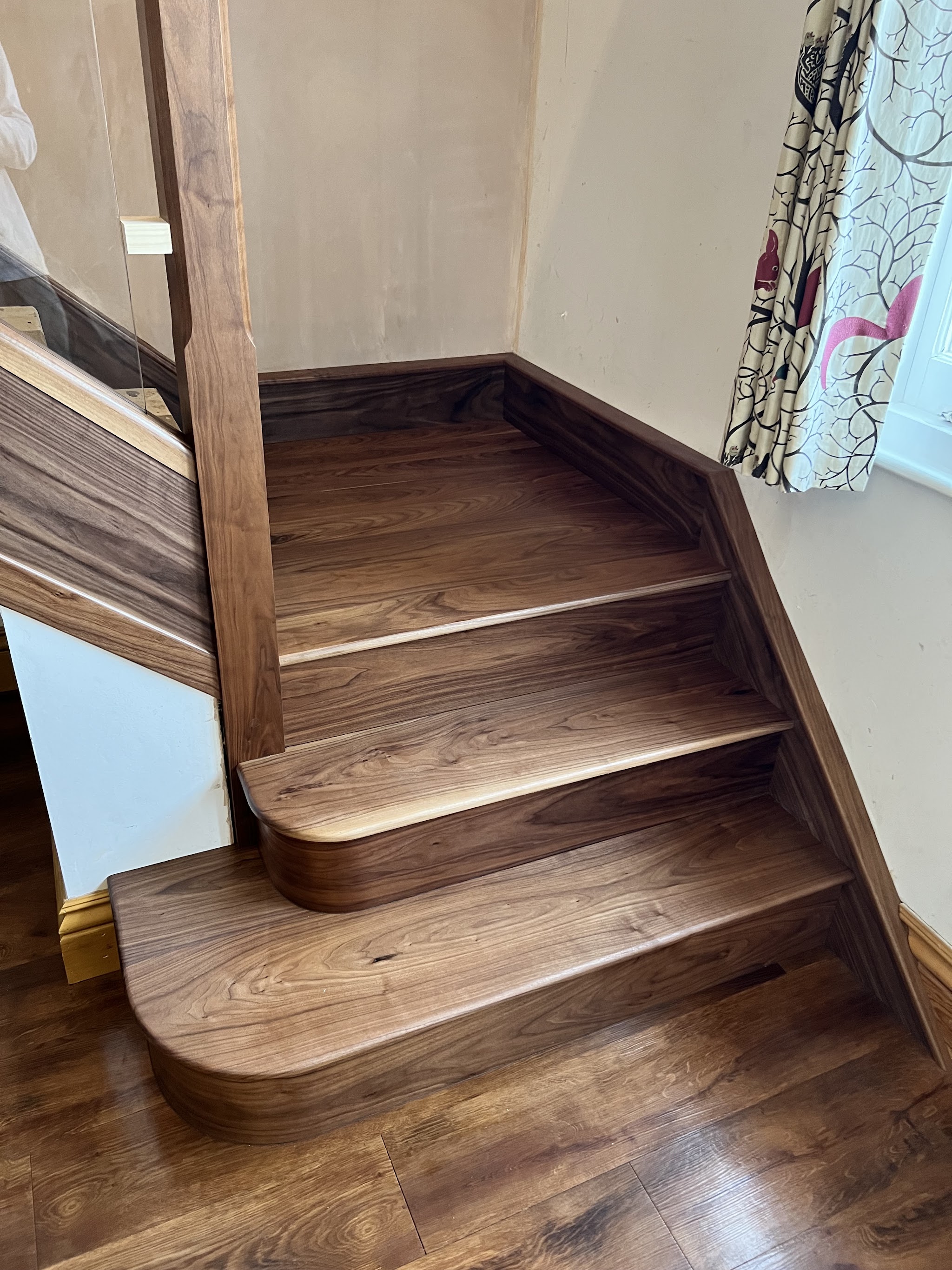 Walnut winder treads with a curved bottom step